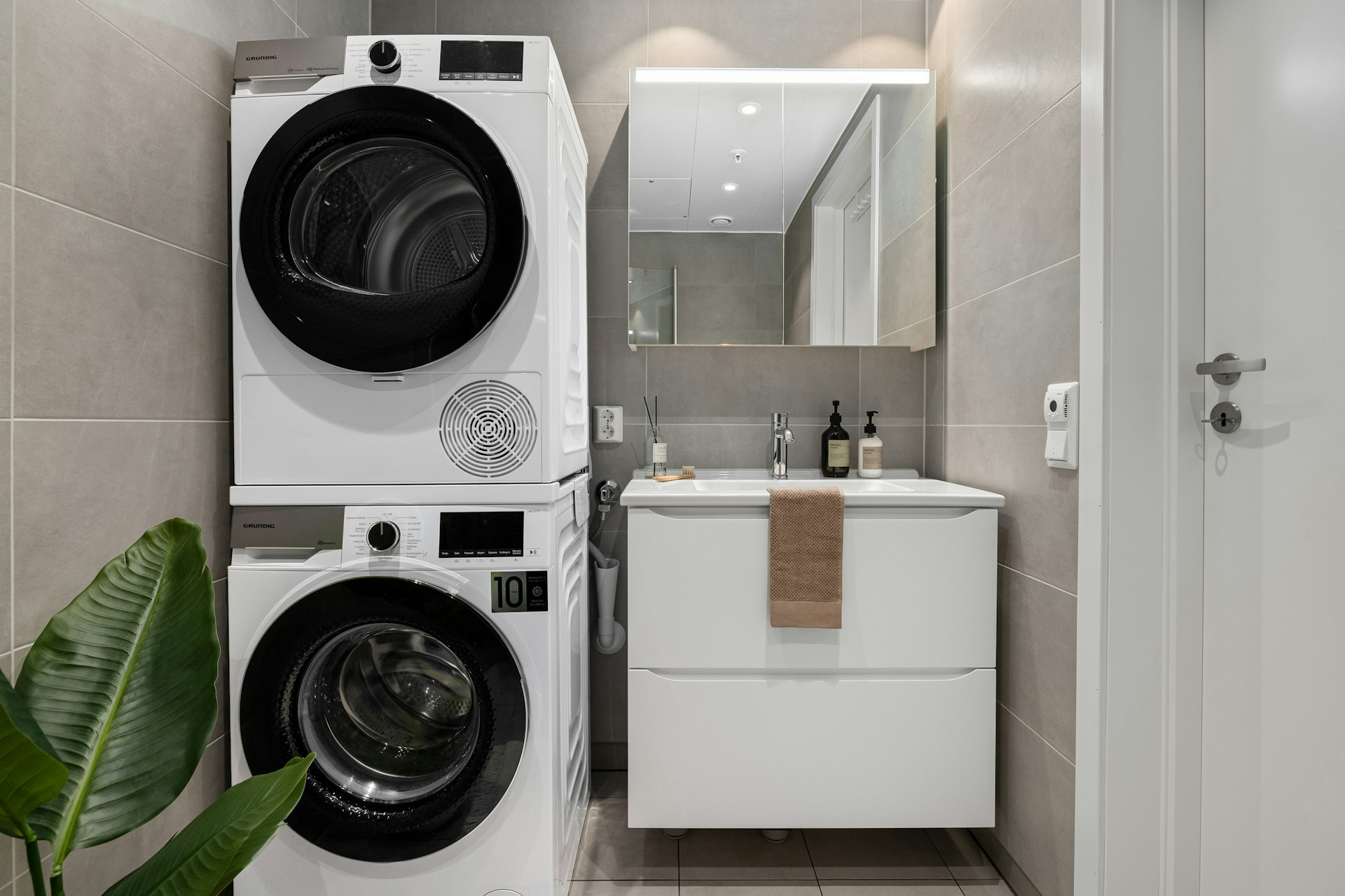 A washer and dryer in a small bathroom